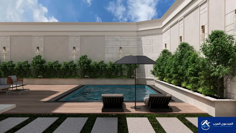 Pool with timber decking, a parasol, loungers and trees along the wall